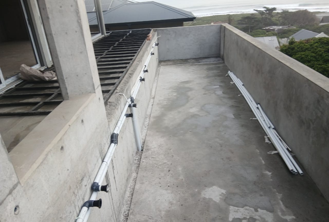Concrete deck with drainage piping installed before finishing