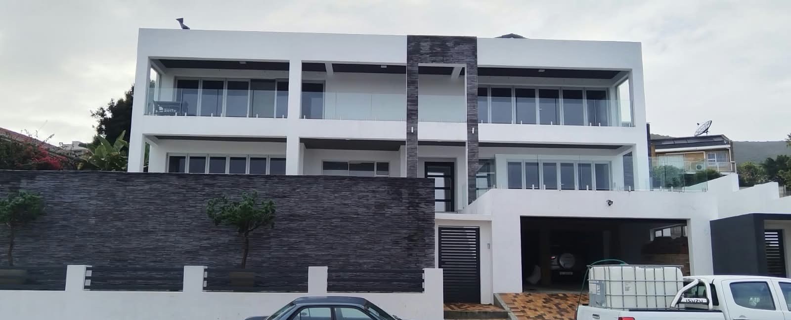 Completed modern double-storey home with boundary wall and paving