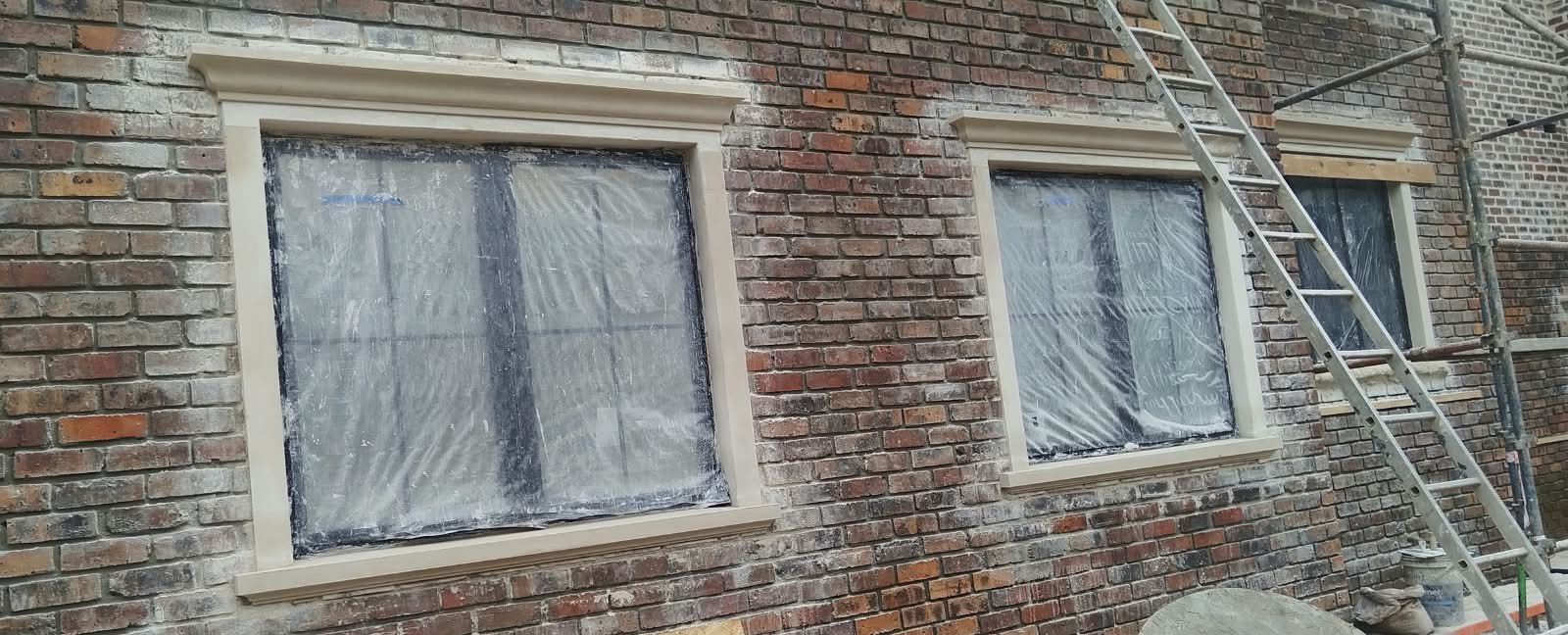 Freshly plastered window reveals on a brick home
