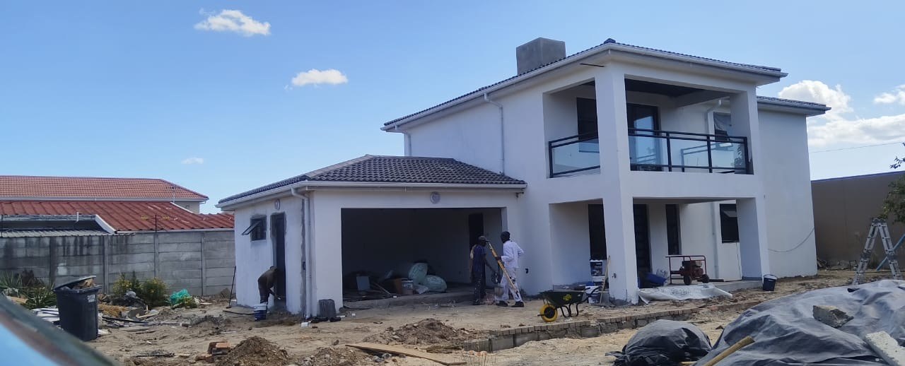 Double-storey house with a newly tiled roof nearing completion